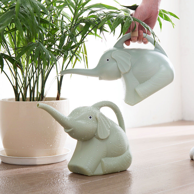 Baby elephant watering flowers